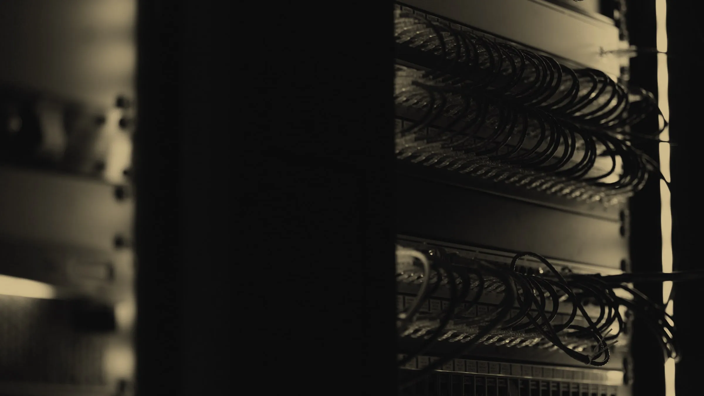 Rows of patched network equipment in a dimly lit server rack.